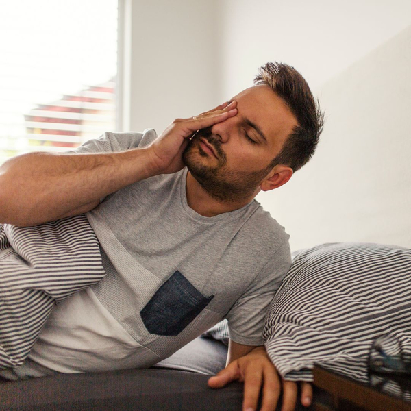 Man waking up tired